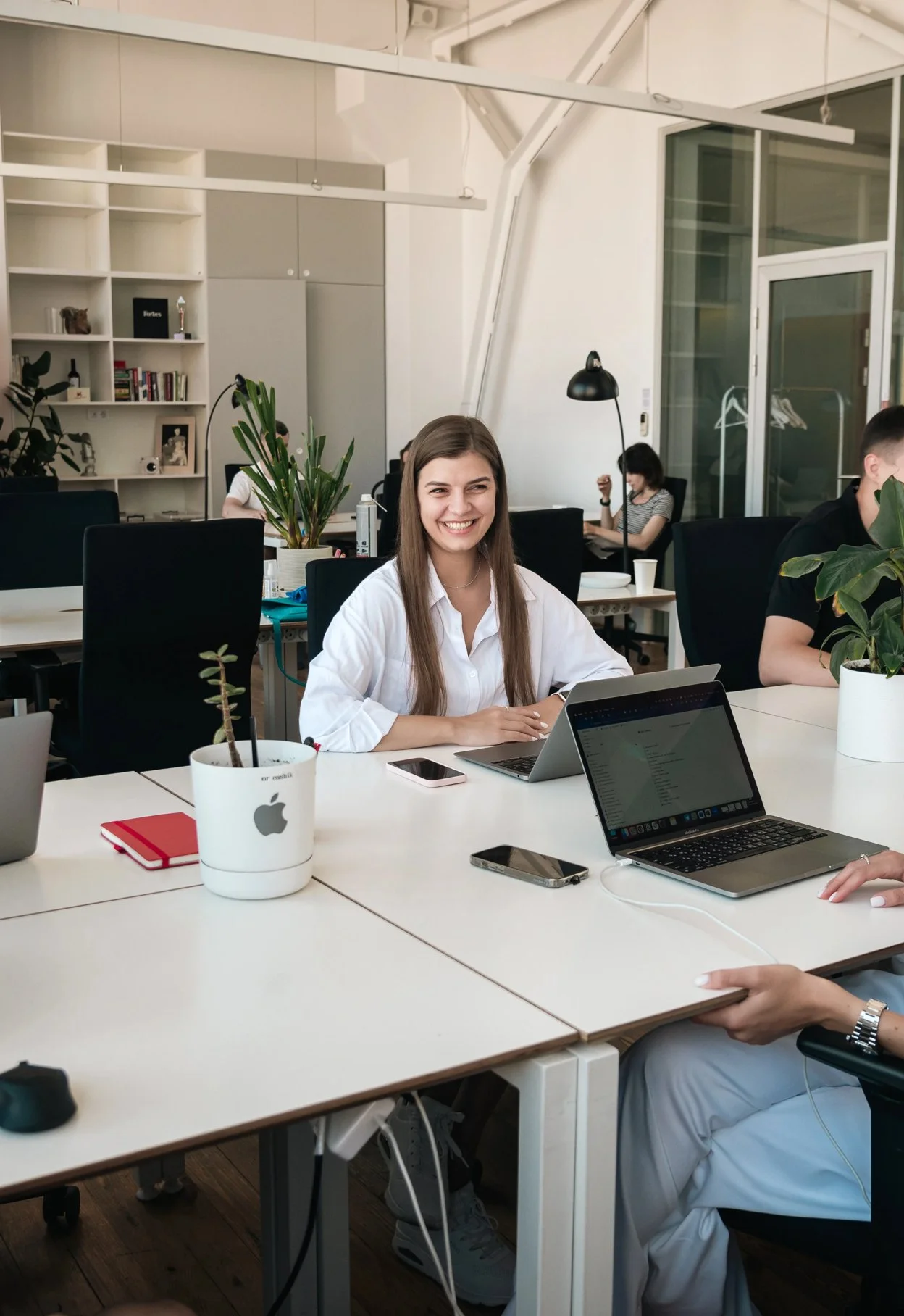 A Belkins team member smiling at her laptop in the office